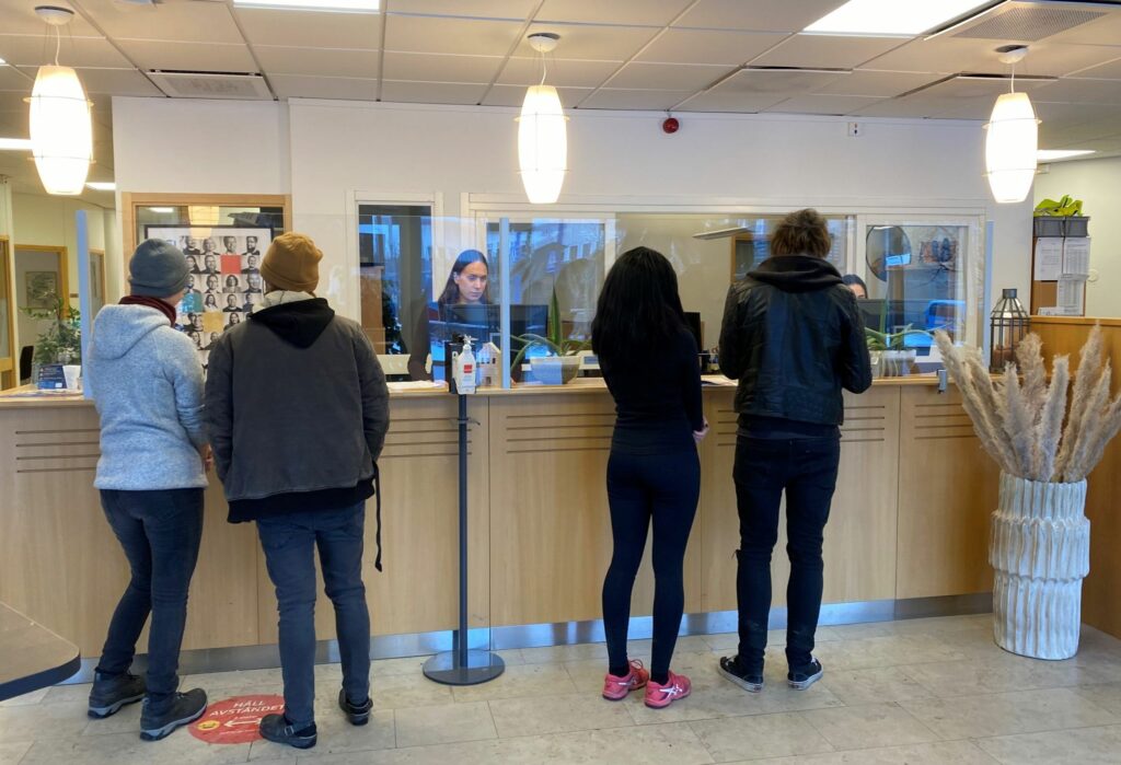 Folk står i Hallstahems kundcenter och pratar med personal